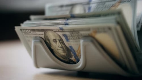 Counter Accumulating Money Cash Denomination of Hundred Dollars Close Up