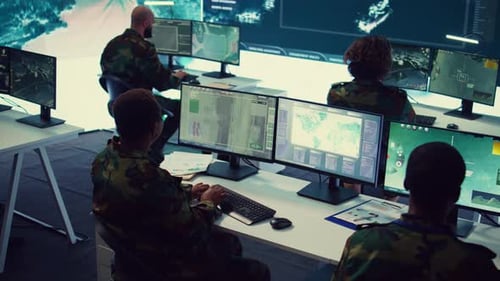People working on computers in a control room