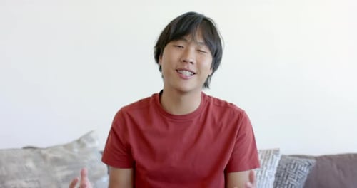 Young Man Talking to Camera on Couch