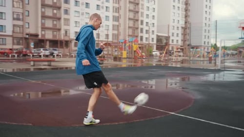 Youth Soccer Practice Playing Football in Rainy Weather Young Athlete Training on Damp City Court