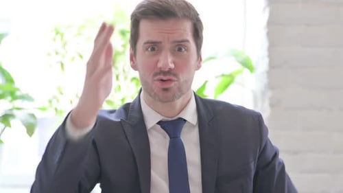 Portrait of Angry Young Businessman Fighting in Office
