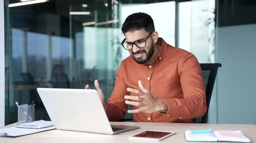 Man Gets Frustrated with Laptop in Office Setting