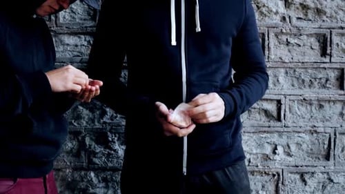 Dark street trade addict hands receive dose while dealer counts euro money