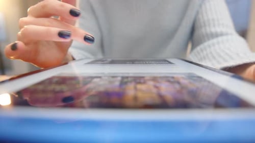 Female Hands Browsing Information in Particular Images in a Tablet