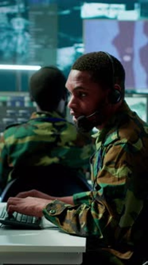 Vertical Video Soldiers in State of the Art Military Control Room Collaborate on Data Analysis