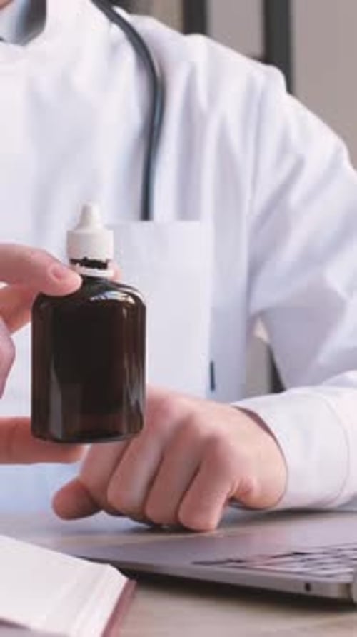 Close Up of Doctor with Medicine Bottle