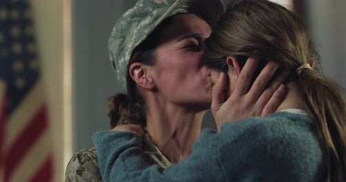 Slow Motion Portrait of Young Happy Female USA Soldier Hugging and Kissing Her Daughter After