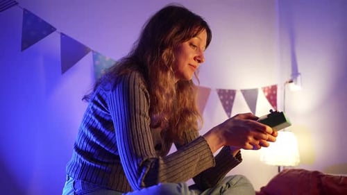 Soft Illumination Casting Colorful Hues Young Woman Sitting Peacefully Gently Playing Kalimba in