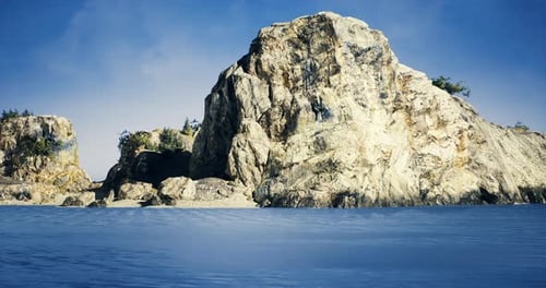 Rocky Coastal Formation with Clear Water Under a Bright Sky