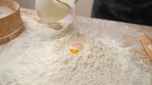 Egg Slowly Falls Into Flour