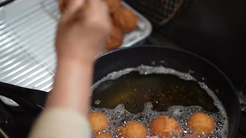 Woman making sata andagi
