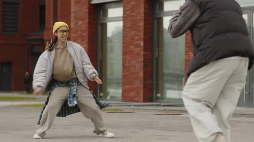 Biracial Girl Dancing Hip Hop on Street