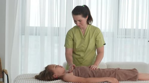 Side View Portrait of Professional Female Masseuse Massaging Breast and Clavicle Muscle of Pretty