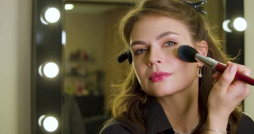Woman Applying Makeup with Brush Close Up