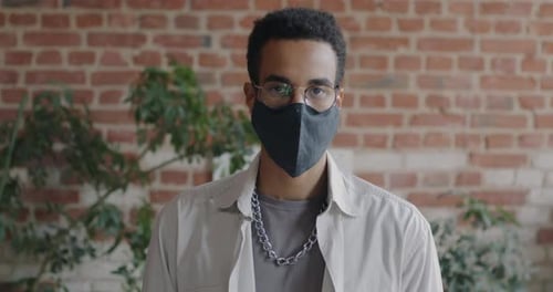 Portrait of African American Businessman Standing in Office Wearing Face Mask During Infection