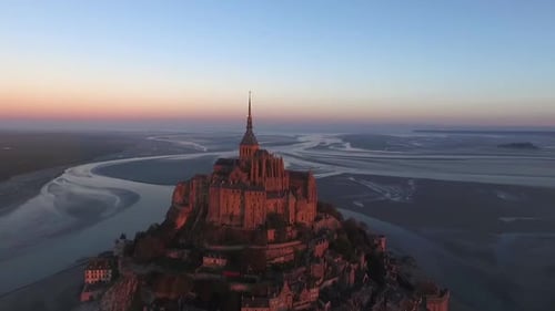 Mont Saint Michel island at dusk, Normandy in France. Aerial drone panoramic view and sky for copy s