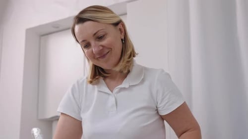 Female Doctor Working in White Lab