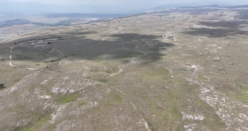 Aerial Shot of Meadows Covered with Soft Mist on a Cloudy Day in the Countryside