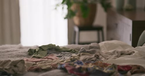 Woman Lying on Bed Covered in Clothing