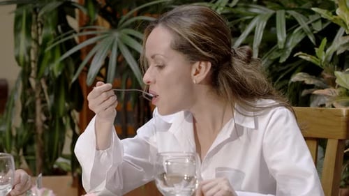 Young woman having dinner in restaurant
