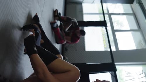 Young Adults Sparring in a Caged Gym