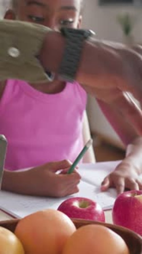Vertical video: Counting kid tapping pencil then doing homework as adult guiding at home, pink top