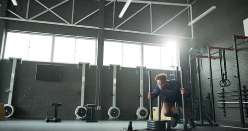 Man, bodybuilder and pushing weight sled at gym for fitness exercise, muscle strength