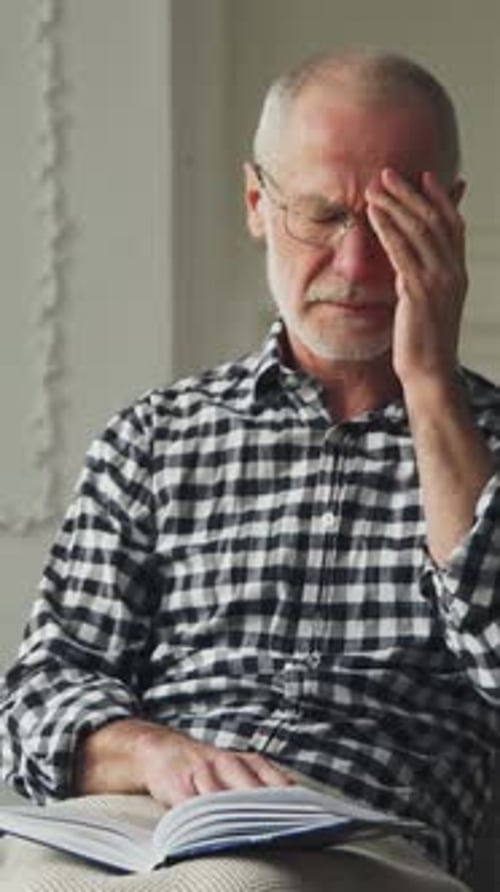 Senior Man Reading then Feeling Unwell