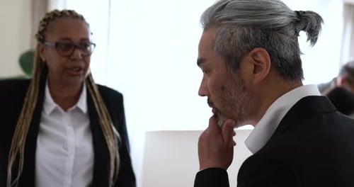 Multiracial business team discussing financial strategy inside a bank office in the USA
