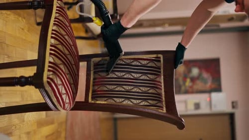Adult Vacuuming Upholstery of Fabric Dining Chair
