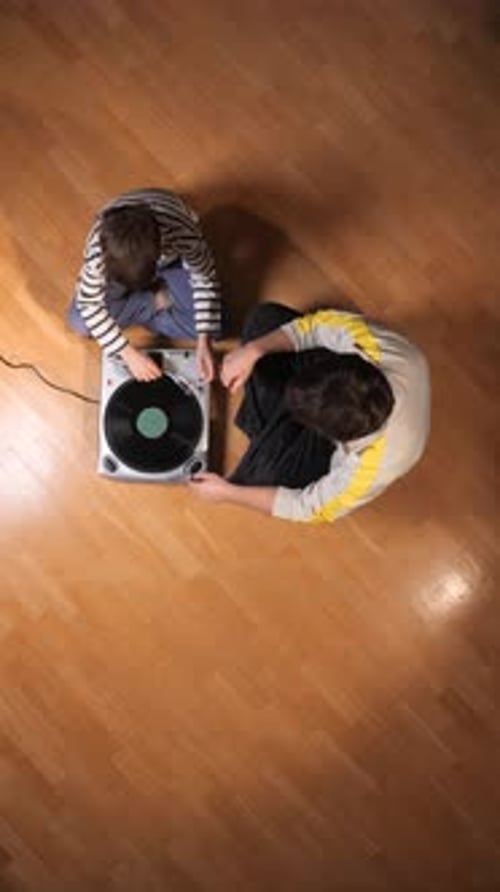 Overhead shot of child and adult with turntable