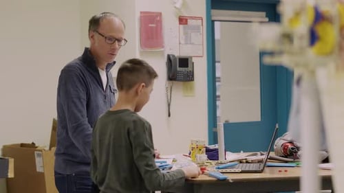 Teacher with Students Building Project in Classroom