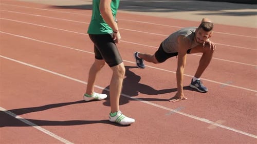 Two Athlets Warm Up at the Stadium