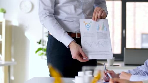 Business Professionals Discussing Charts in an Office Setting