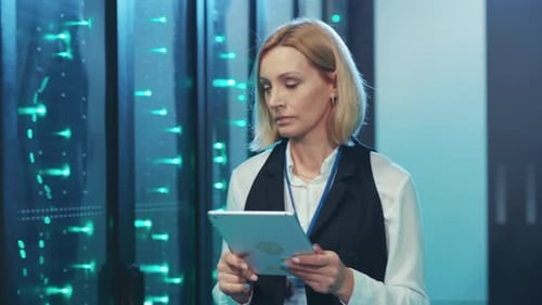 Employees Using Tablets in Modern Server Room