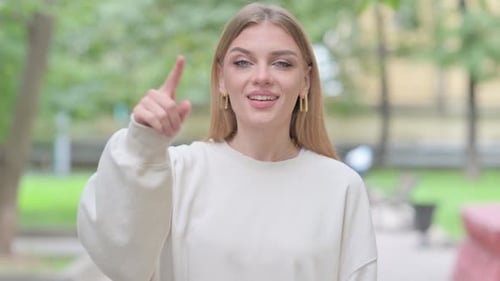 Smiling Blonde Woman Pointing At The Camera