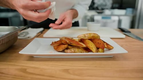 Chef Arranging Roasted Potatoes on a Plate