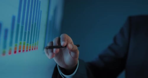 Closeup View of Hands of African Businessman Showing Profit Chart in Business Meeting Prores
