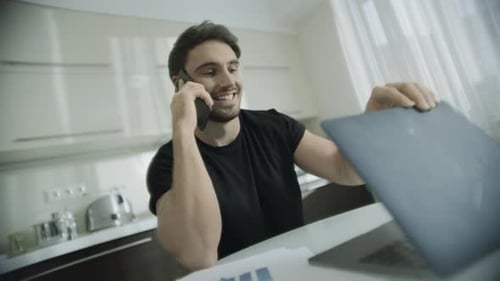 Man working from home talking on phone