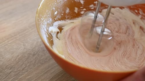 Creamy Batter Being Mixed in Orange Bowl