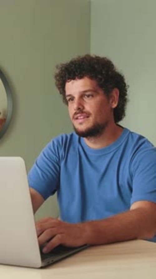 Adult Male Typing On Laptop From Home