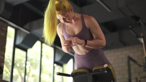 Gorgeous Female Professional Bodybuilder Doing Workout Exercises in Gym