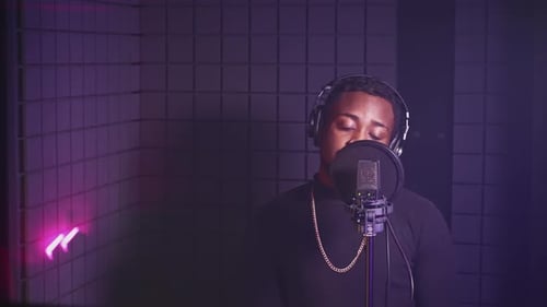 Male Singer Recording a New Song in Professional Music Studio