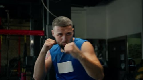 Male boxer training fit man doing boxing in gym young man doing warm up stretching muscles
