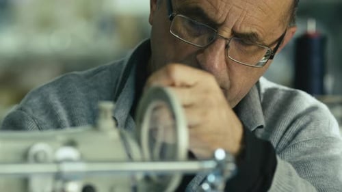 Man Focused on Working at Machine Close Up