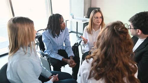 Group of colleagues meeting in bright office