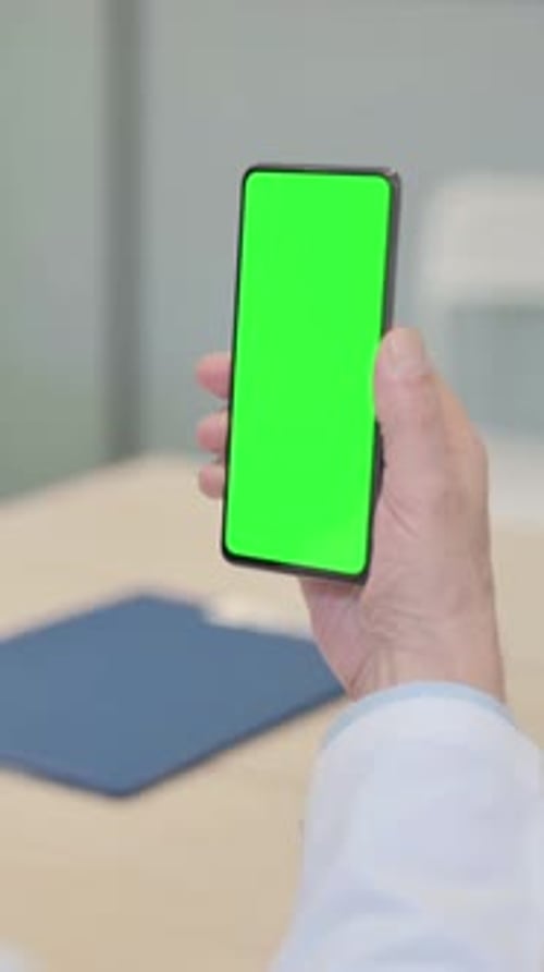 Close Up of Senior Doctor Using Smartphone with Green Screen, vertical video