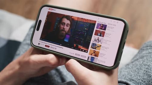 Close Up of Teenager Watching Video About Investment or Cryptocurrency on Mobile Phone