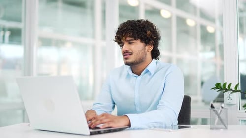 Frustrated employee complains about poor performance of computer program on laptop while sitting in