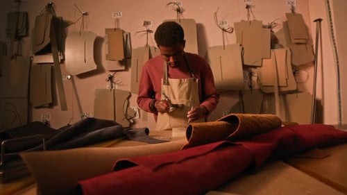 Craftsman Cutting Leather in a Workshop